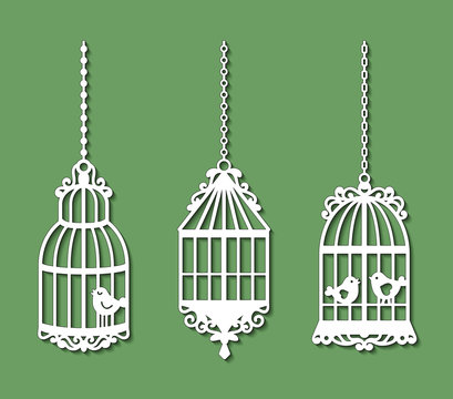 Set of laser cut template of birdcages. Openwork silhouette of cages for birds with lace ornament. Decoration for paper cutout. Design for laser or die cutting. Vector illustration on green background