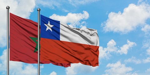 Morocco and Chile flag waving in the wind against white cloudy blue sky together. Diplomacy concept, international relations.