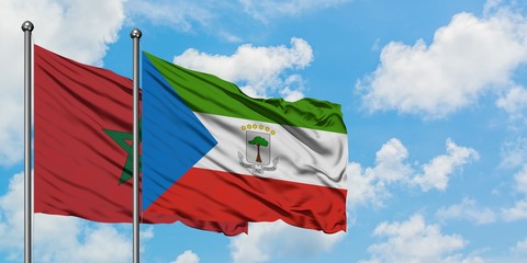 Morocco and Equatorial Guinea flag waving in the wind against white cloudy blue sky together. Diplomacy concept, international relations.