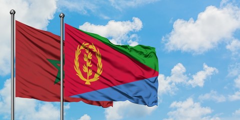 Morocco and Eritrea flag waving in the wind against white cloudy blue sky together. Diplomacy concept, international relations.
