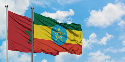 Morocco and Ethiopia flag waving in the wind against white cloudy blue sky together. Diplomacy concept, international relations.