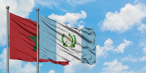 Morocco and Guatemala flag waving in the wind against white cloudy blue sky together. Diplomacy concept, international relations.