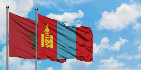 Morocco and Mongolia flag waving in the wind against white cloudy blue sky together. Diplomacy concept, international relations.