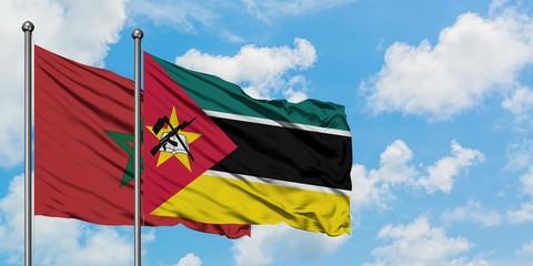 Morocco and Mozambique flag waving in the wind against white cloudy blue sky together. Diplomacy concept, international relations.