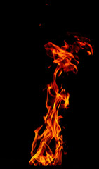 Fire flame isolated on black background. Vertical flare of fire. For action design.
