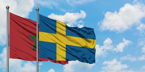 Morocco and Sweden flag waving in the wind against white cloudy blue sky together. Diplomacy concept, international relations.