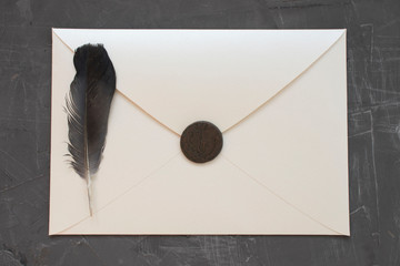 envelope with seal and letter on concrete background