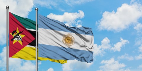 Mozambique and Argentina flag waving in the wind against white cloudy blue sky together. Diplomacy concept, international relations.