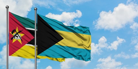 Mozambique and Bahamas flag waving in the wind against white cloudy blue sky together. Diplomacy concept, international relations.