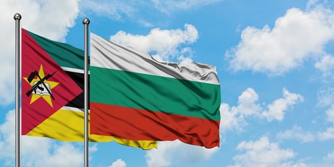 Mozambique and Bulgaria flag waving in the wind against white cloudy blue sky together. Diplomacy...