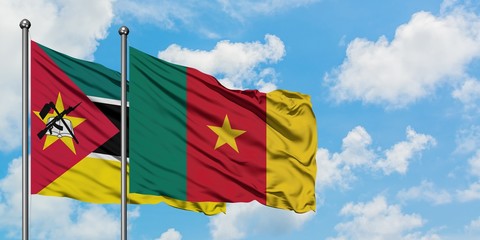 Mozambique and Cameroon flag waving in the wind against white cloudy blue sky together. Diplomacy concept, international relations.