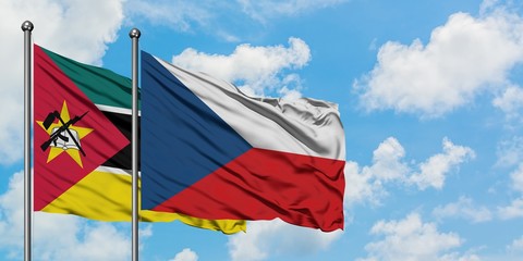 Mozambique and Czech Republic flag waving in the wind against white cloudy blue sky together. Diplomacy concept, international relations.