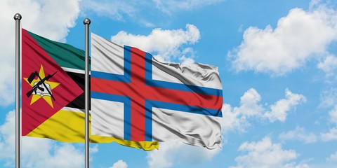 Mozambique and Faroe Islands flag waving in the wind against white cloudy blue sky together. Diplomacy concept, international relations.
