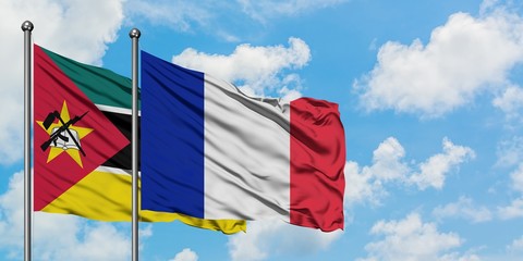 Mozambique and France flag waving in the wind against white cloudy blue sky together. Diplomacy concept, international relations.