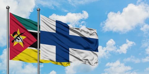 Mozambique and Finland flag waving in the wind against white cloudy blue sky together. Diplomacy concept, international relations.