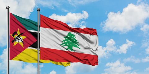 Mozambique and Lebanon flag waving in the wind against white cloudy blue sky together. Diplomacy concept, international relations.