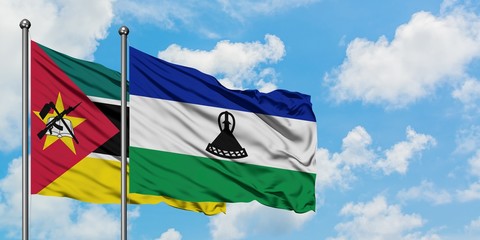 Mozambique and Lesotho flag waving in the wind against white cloudy blue sky together. Diplomacy concept, international relations.