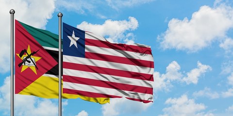 Mozambique and Liberia flag waving in the wind against white cloudy blue sky together. Diplomacy concept, international relations.