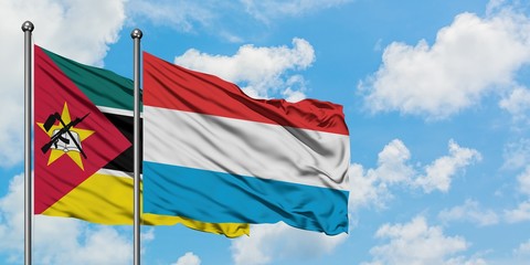 Mozambique and Luxembourg flag waving in the wind against white cloudy blue sky together. Diplomacy concept, international relations.