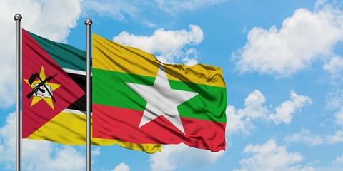Mozambique and Myanmar flag waving in the wind against white cloudy blue sky together. Diplomacy concept, international relations.