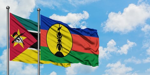 Mozambique and New Caledonia flag waving in the wind against white cloudy blue sky together. Diplomacy concept, international relations.