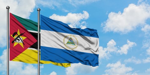 Mozambique and Nicaragua flag waving in the wind against white cloudy blue sky together. Diplomacy concept, international relations.