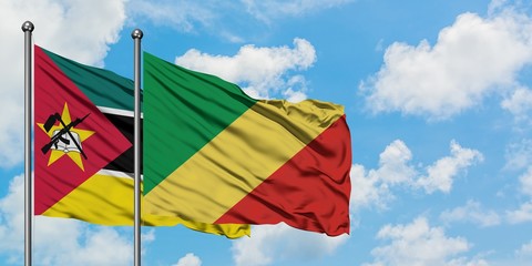 Mozambique and Republic Of The Congo flag waving in the wind against white cloudy blue sky together. Diplomacy concept, international relations.