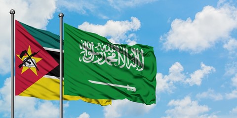 Mozambique and Saudi Arabia flag waving in the wind against white cloudy blue sky together. Diplomacy concept, international relations.