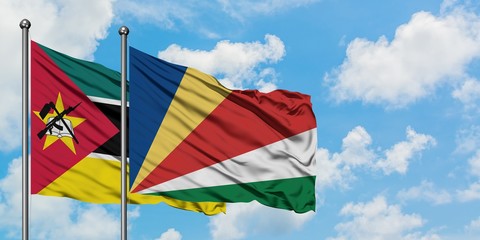 Mozambique and Seychelles flag waving in the wind against white cloudy blue sky together. Diplomacy concept, international relations.