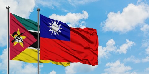Mozambique and Taiwan flag waving in the wind against white cloudy blue sky together. Diplomacy concept, international relations.