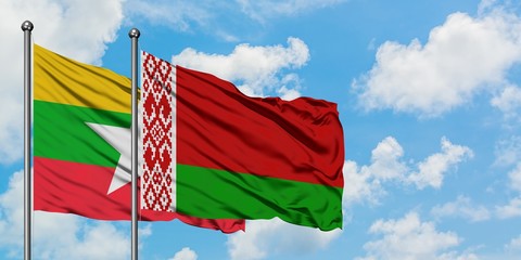 Myanmar and Belarus flag waving in the wind against white cloudy blue sky together. Diplomacy concept, international relations.