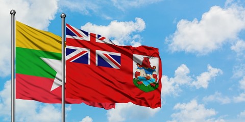 Myanmar and Bermuda flag waving in the wind against white cloudy blue sky together. Diplomacy concept, international relations.