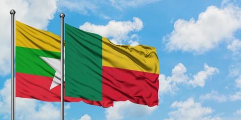 Myanmar and Benin flag waving in the wind against white cloudy blue sky together. Diplomacy concept, international relations.