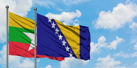 Myanmar and Bosnia Herzegovina flag waving in the wind against white cloudy blue sky together....
