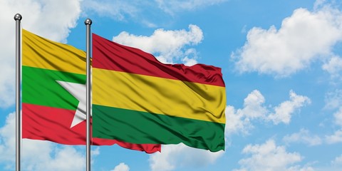 Myanmar and Bolivia flag waving in the wind against white cloudy blue sky together. Diplomacy concept, international relations.