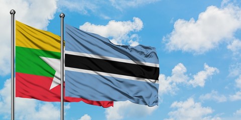 Myanmar and Botswana flag waving in the wind against white cloudy blue sky together. Diplomacy concept, international relations.