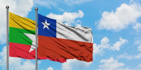 Myanmar and Chile flag waving in the wind against white cloudy blue sky together. Diplomacy...