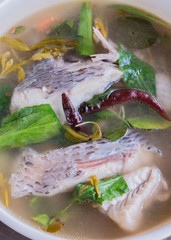 hot and sour soup tilapia fish in white plate . selective focus.