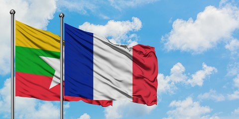Myanmar and France flag waving in the wind against white cloudy blue sky together. Diplomacy concept, international relations.