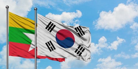 Myanmar and South Korea flag waving in the wind against white cloudy blue sky together. Diplomacy concept, international relations.