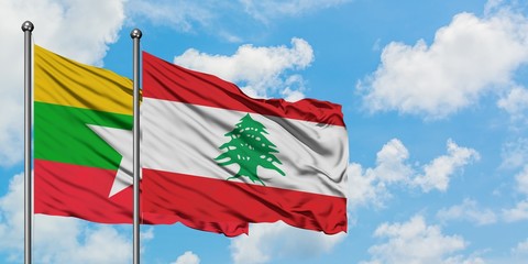 Myanmar and Lebanon flag waving in the wind against white cloudy blue sky together. Diplomacy concept, international relations.
