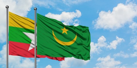 Myanmar and Mauritania flag waving in the wind against white cloudy blue sky together. Diplomacy concept, international relations.