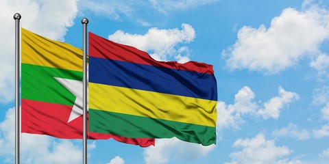 Myanmar and Mauritius flag waving in the wind against white cloudy blue sky together. Diplomacy concept, international relations.