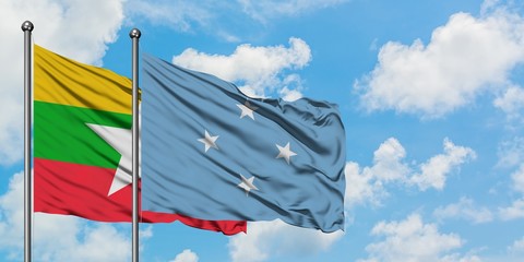 Myanmar and Micronesia flag waving in the wind against white cloudy blue sky together. Diplomacy concept, international relations.