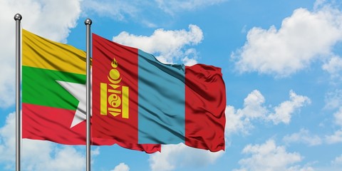 Myanmar and Mongolia flag waving in the wind against white cloudy blue sky together. Diplomacy concept, international relations.
