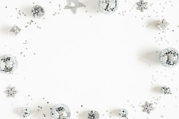 Christmas composition. Frame made of christmas silver decorations on white background. Flat lay, top view, copy space
