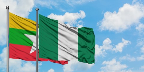 Myanmar and Nigeria flag waving in the wind against white cloudy blue sky together. Diplomacy concept, international relations.