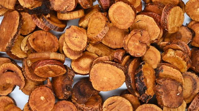 top view herb medicine ZhiGanCao or Radix Glycyrrhizae Preparata or Prepared Liquorice Root rotate and pause