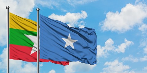 Myanmar and Somalia flag waving in the wind against white cloudy blue sky together. Diplomacy concept, international relations.