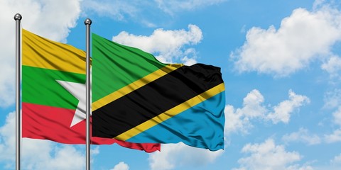 Myanmar and Tanzania flag waving in the wind against white cloudy blue sky together. Diplomacy concept, international relations.